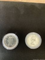 Two 1958 Canadian silver dollars showing obverse side with Queen Elizabeth II's profile and inscription.