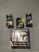 Top view of the Star Wars figures and Clone Trooper Mask cereal box arranged on the floor, showing front of the packages.