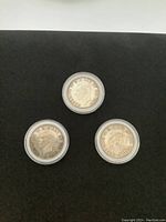 Three 1939 Canadian silver dollar coins shown from the obverse side featuring King George VI profiles.