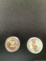 Two vintage silver rounds from 1985 and 1986 shown side by side with the Liberty Bell design facing up.