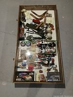 Top-down view of case showing glass top and interior space with various collectibles inside (not included).