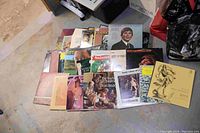 Two boxes of vintage vinyl records laid out on the floor showing a variety of album covers, mostly classical and crooner styles