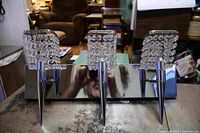 Front view of bathroom light fixture showing three chrome lights with crystal bead shades, arranged horizontally on a rectangular chrome base.