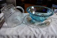 Blue round Candlewick bowl with beaded rim and small chip on foot alongside clear tray with sterling silver overlay