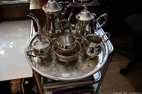 Full view of the silver plate tea set arranged on the Viking plate tray showing all items together.
