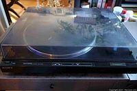 Sony full automatic stereo turntable with plastic dust cover, front view showing controls and brand.