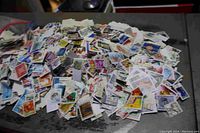 Image showing a large loose pile of assorted stamps of various designs and colors, mainly used.