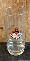 Clear vintage beer glass with Riegeler Bier logo and hops decoration on front.