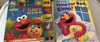 Photo showing two Halloween and bedtime-themed Sesame Street children's books with Elmo on the covers.