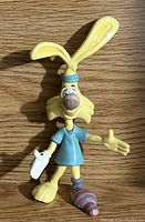 Photo of Bonkers PVC rabbit figurine on wooden surface, showing full frontal view