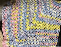 Close-up image of crochet throw showing texture, stitch pattern, and colors
