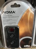 Photo of new Noma outdoor block heater timer in sealed retail packaging showing device and label details.