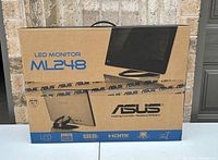 Closed original box of ASUS LED Monitor ML248, featuring printed images and branding.