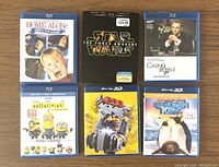 Front view showing Blu-Ray cases for 6 movies: Home Alone, Star Wars: The Force Awakens, Casino Royale, Minions, The Lego Movie 3D, Happy Feet 2 3D.