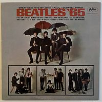 Front cover of Beatles '65 album showing band members seated with umbrellas, album title and track list above.