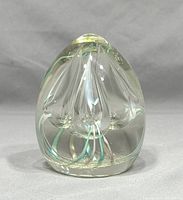 Front angled view showing the clear glass with the internal green and clear glass floral design and fine bubble details.