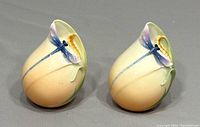 Pair of vintage Franz porcelain salt and pepper shakers with dragonfly motifs, side view.