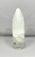 Tall clear glass vase photographed from front showing encased crackle texture inside the glass and thick weighted base.