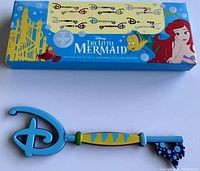 Disney The Little Mermaid Flounder & Sebastian Collector Key with box, featuring colorful Little Mermaid packaging and detailed key design.