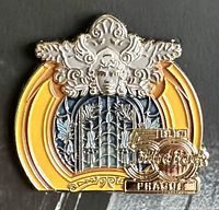 Close-up image of Hard Rock 50th Local Core PRG collector's pin showing detailed embossed silver face, wings, yellow-orange enamel arcs, and 50th anniversary emblem with Prague text and globe.