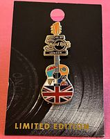 Photo of the Hard Rock Limited Edition London guitar-shaped collector's pin mounted on black cardboard backing with 'LIMITED EDITION' text in gold.