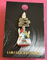 Full view of the limited edition Hard Rock Los Angeles California Republic guitar-shaped pin mounted on a black card backing with gold text.