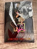 Photo of the limited edition Hard Rock 50th Punk Rocker 80s Decade Girl collectible pin in original sealed packaging, showing the punk rocker girl holding a pink electric guitar.