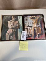 Two framed watercolor paintings depicting nude male figures. One faces forward with arms crossed, the other faces away with arms raised. Both artworks are signed Char Fitzpatrick and dated 1977.