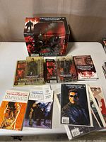Full lot showing boxed Terminator 3 figure set, two Terminator Omnibus comics, and other comics and a book.