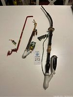 Overview photo of three vintage German smoking pipes on white background showing the pipes' full length, colors, and attached glass elements.