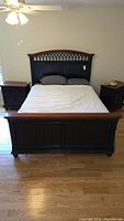 Full front view of assembled queen bed frame with bedding
