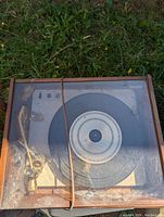 Top-down view of the Empire record player in wooden base with clear plastic dust cover