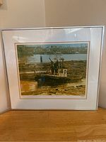 Framed printing showcasing a logging boat on a river with logs, set against an industrial background.