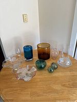 Overview of all twelve glass pieces on wood table