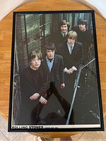 Framed color poster of the Rolling Stones standing on stairs outdoors with the title 'Rolling Stones London May 1965' visible at the bottom.