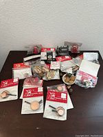 Overview of the lot showing multiple miniature dollhouse kitchen accessories and dishes, mostly in original packaging with red and white labels.