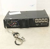 Rear and top view of Fanon Pro Power 65 professional power amplifier showing power cord, input/output ports, heat sink, and missing leg.