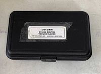 Closed black plastic carrying case with label showing model DV-24N and DV-22N Digital Vacuum Gauge by JB Industries Inc.
