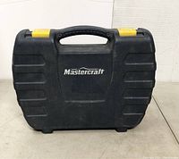 Black hard plastic carrying case with yellow latches, Mastercraft logo on lid.