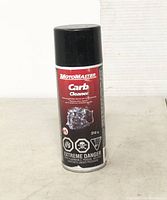 Photo of a single aerosol can of MotoMaster Carb Cleaner, 312 g, standing upright on a white surface with a white background. The label shows engine illustration and safety warnings.