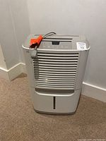 Front view of Frigidaire humidifier showing grille and water level indicator.