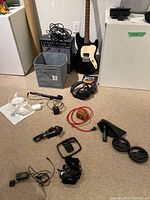 Overview of lot: guitar, amp, headphones, microphones, cables, strings