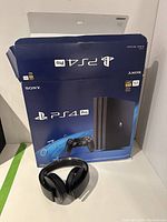 PS4 Pro retail box with headset in front
