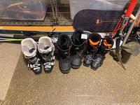 Three pairs of ski and snowboard boots showing exterior condition and details