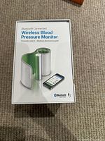 Photo of the boxed wireless blood pressure monitor packaging showing product image and Bluetooth connectivity