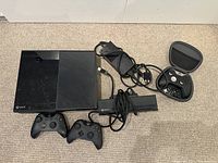Overview of Xbox One console, two standard controllers, Kinect sensor, AC power supply, and Xbox Elite controller in case