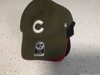 Olive green '47 brand hat with white 'C' logo and adjustable strap.