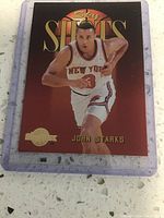 Sky Shots John Starks basketball card, front view showing player in white Knicks uniform with gold lettering