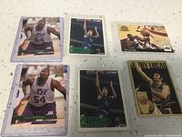 Four basketball cards display featuring Luther Wright in Utah Jazz uniform with number 54, Christian Laettner shooting, Karl Malone in action, and Jerry Lucas portrait.