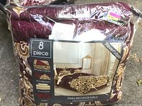 Front view of 8-piece king bed ensemble comforter set packaging showing reversible comforter design